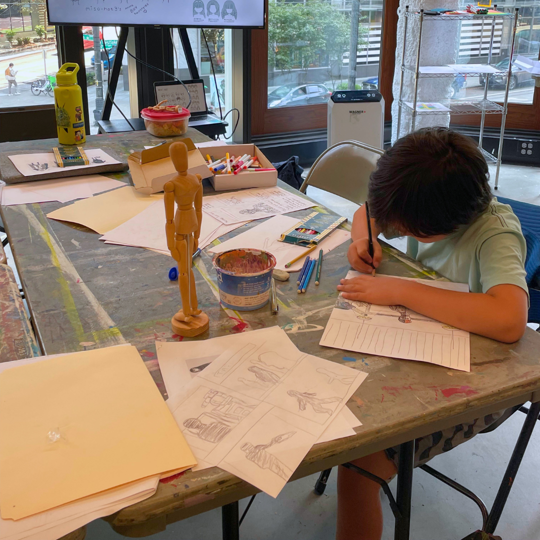 A child draws at a table